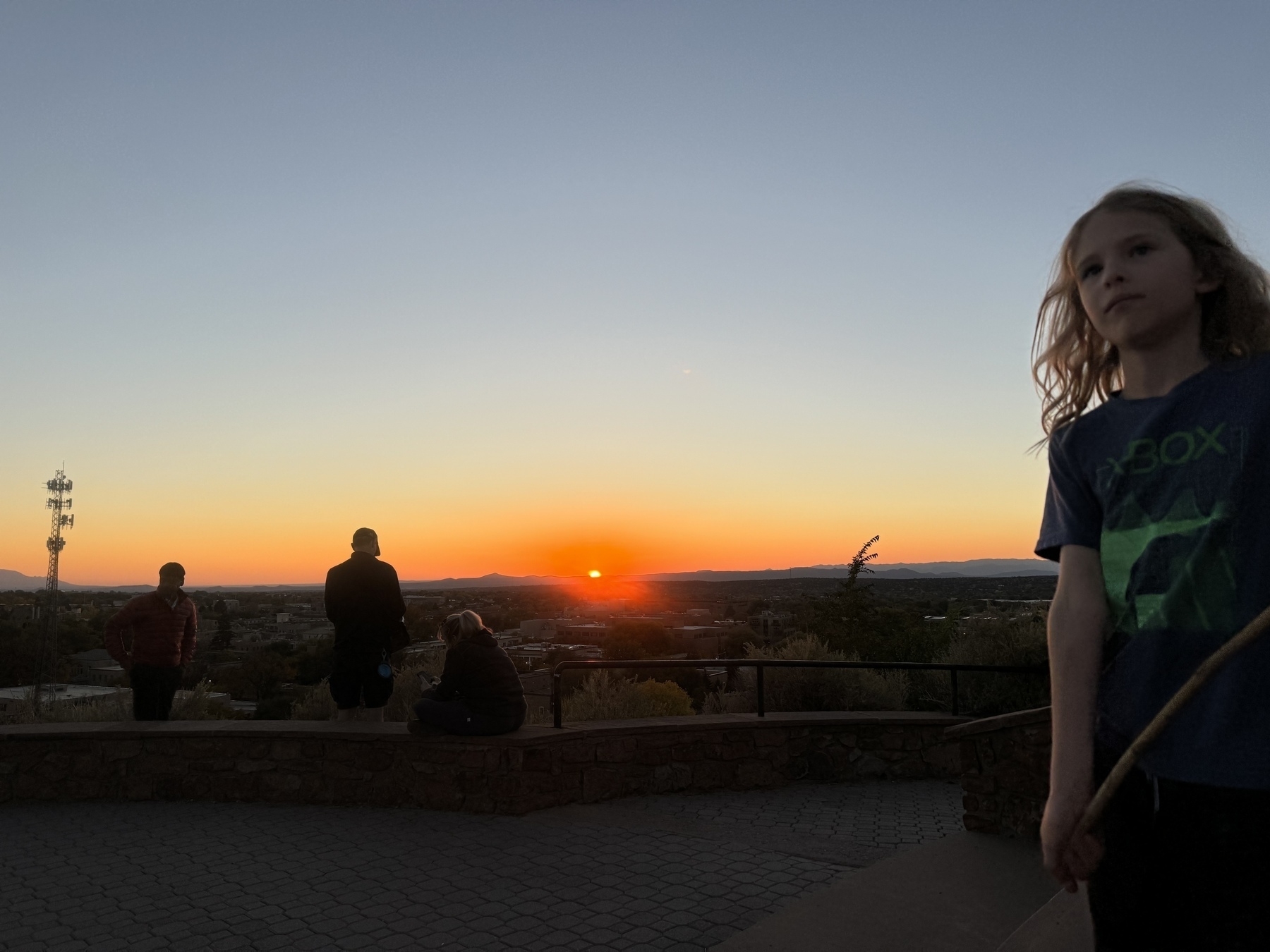 Sun setting over the mountains with downtown Santa Fe in the foreground