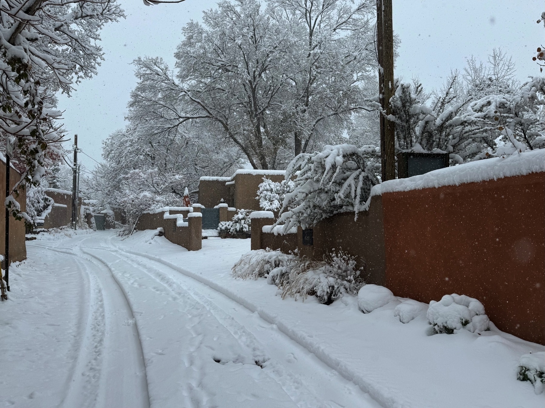 Adobe houses covered in snow on Arroyo Tenorio in Santa Fe